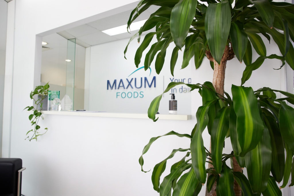 The reception of Maxum Foods in Milton with a potted floor Happy plant and trailing pothos.